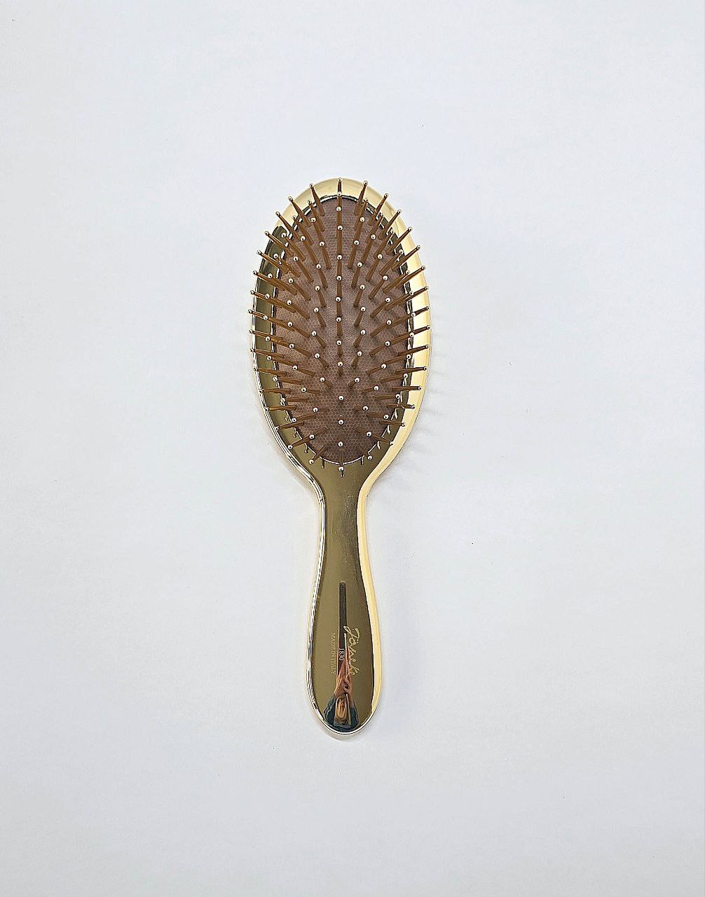 Golden air-cushioned brush with gold pins